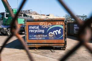 view of a dumpster rental through a fence