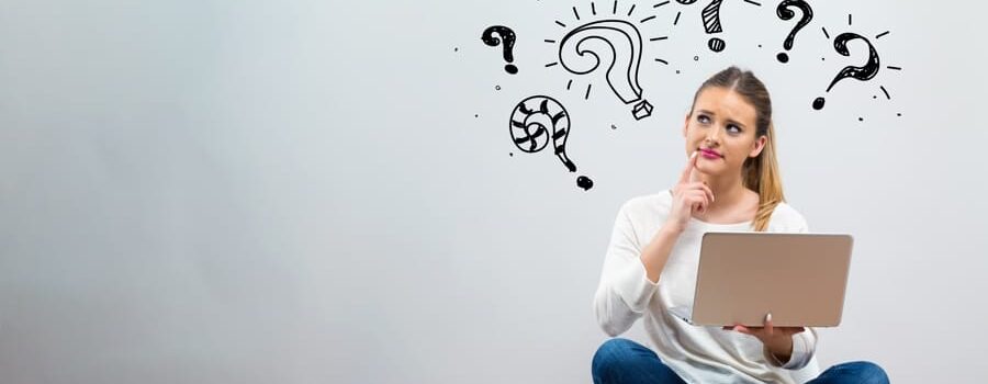 woman sitting on a chair with question marks above her head