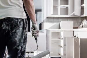 man painting renovated kitchen