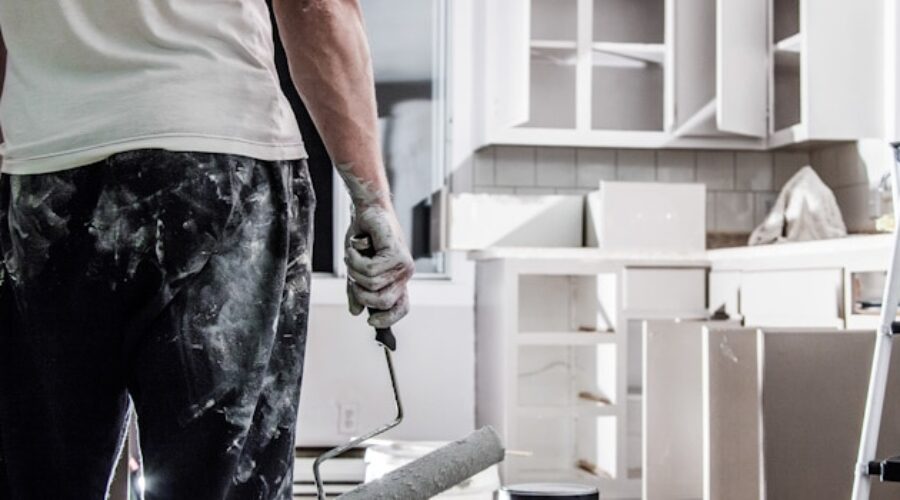 man painting renovated kitchen